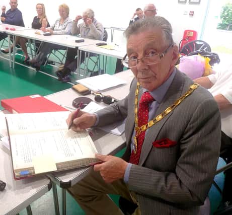 Mayor and chairman Cllr Paul Holbrook signing the Declaration of Acceptance. Photo by Hailsham Town Council.