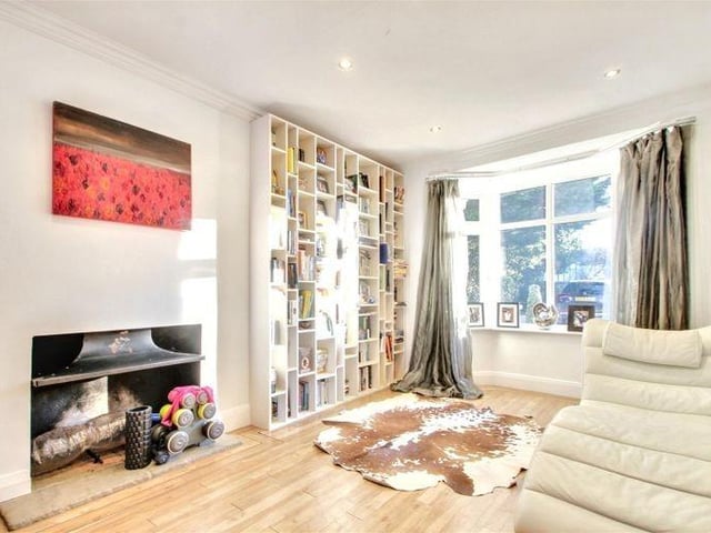 The spacious, double-aspect, L-shaped living room has bi-fold doors to the garden
