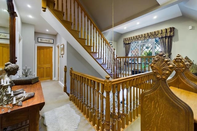 The balustrade staircase leads up to a galleried landing