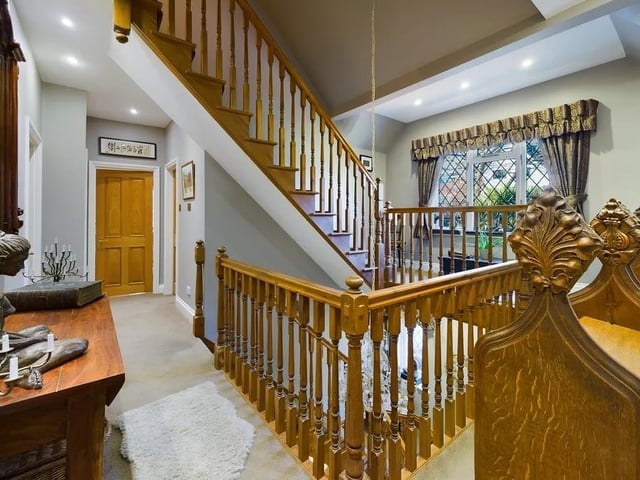 The balustrade staircase leads up to a galleried landing