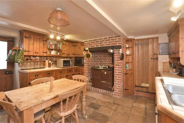 Exposed brick and flagstone floors gives the kitchen a very traditional feel.