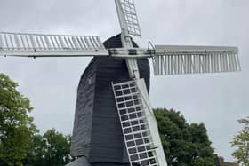 High Salvington Windmill in mourning, with the sails stopped just beyond their highest point