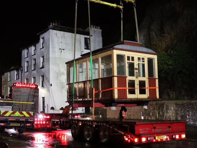 A carriage being lifted onto a lorry