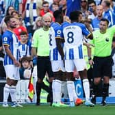 Referee Tony Harrington (R) speaks with Brighton's players as he disallows their third goal scored by Brighton's Argentinian midfielder Alexis Mac Allister in their Premier League match against Leicester