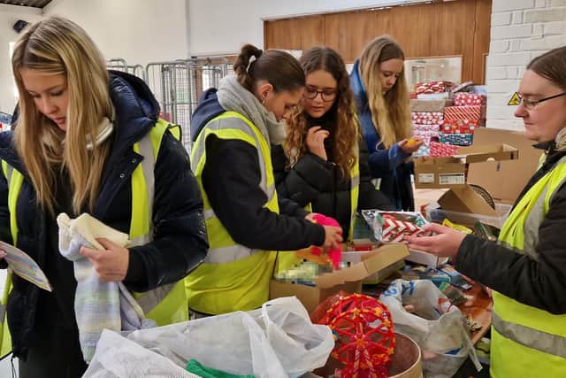 Students from Hurtwood House School in Surrey packing boxes