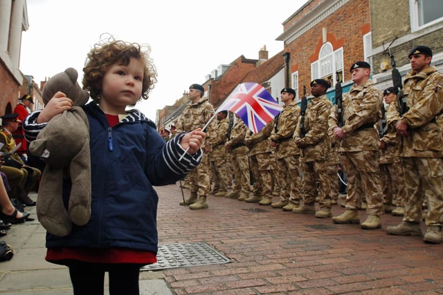 Three-year-old Gwen Sargent waving for her daddy's regiment