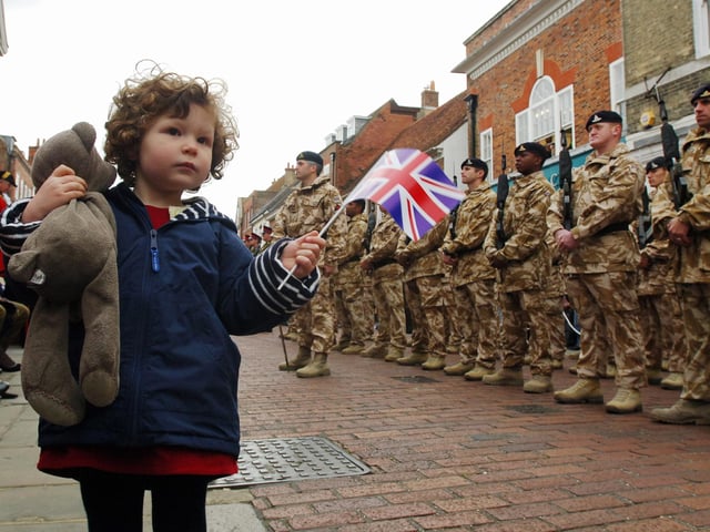 Three-year-old Gwen Sargent waving for her daddy's regiment