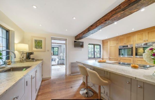 There is a bespoke kitchen with hand-made solid oak unit featuring AEG appliances including separate steam oven as well as a standard oven, induction hob with draw down extractor and various integrated appliances including fridge/freezer and dishwasher.