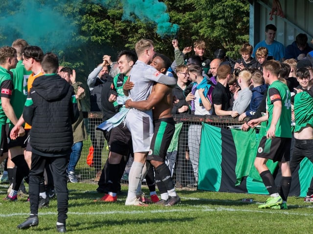 Burgess Hill Town players, fans and staff celebrate surviving in the Isthmian south east division at the end of their 0-0 draw with Beckenham