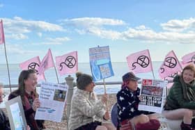 Campaigners from Extinction Rebellion and the Clean Water Action Group holding their protest on St Leonards beach in March 2023