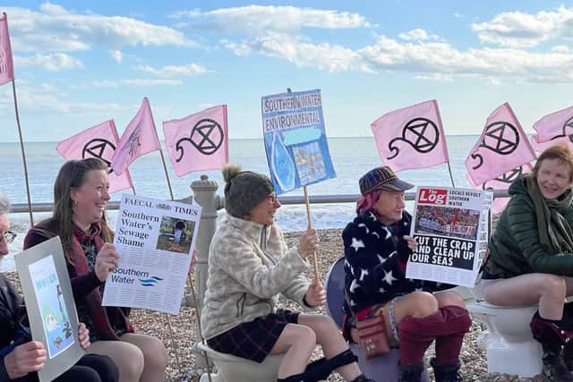 Campaigners from Extinction Rebellion and the Clean Water Action Group holding their protest on St Leonards beach in March 2023