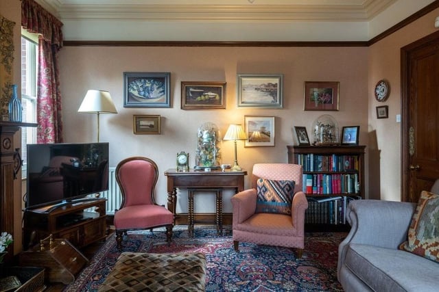 The drawing room has an Edwardian wooden surround fireplace