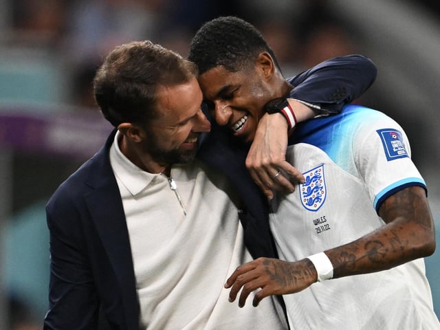 TOPSHOT - England's coach Gareth Southgate congratulates England's forward #11 Marcus Rashford as he is substituted after scoring two goals during the Qatar 2022 World Cup Group B football match between Wales and England at the Ahmad Bin Ali Stadium in Al-Rayyan, west of Doha on November 29, 2022. (Photo by Paul ELLIS / AFP) (Photo by PAUL ELLIS/AFP via Getty Images)