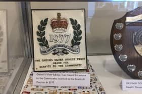 The Crawley Museum exhibit showing the Queen's Silver Jubilee award for Bewbush Playbus in 1977