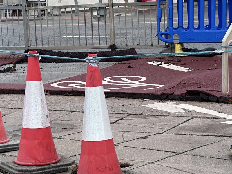 Part of the pavement on Hastings seafront has been damaged following torrential rain. Picture: John Bownas