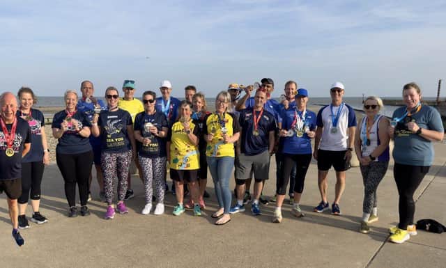 Members of Arunners who took part in events in April proudly show off their finishers’ shirts and medals