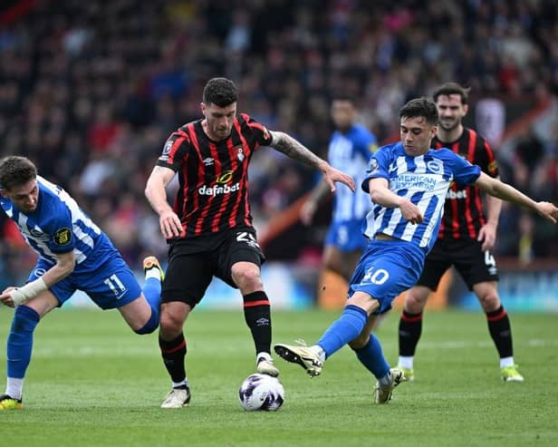 BOURNEMOUTH, ENGLAND - APRIL 28: Marcos Senesi of AFC Bournemouth is challenged by Billy Gilmour and Facundo Buonanotte of Brighton & Hove Albion during the Premier League match between AFC Bournemouth and Brighton & Hove Albion at Vitality Stadium on April 28, 2024 in Bournemouth, England. (Photo by Mike Hewitt/Getty Images)