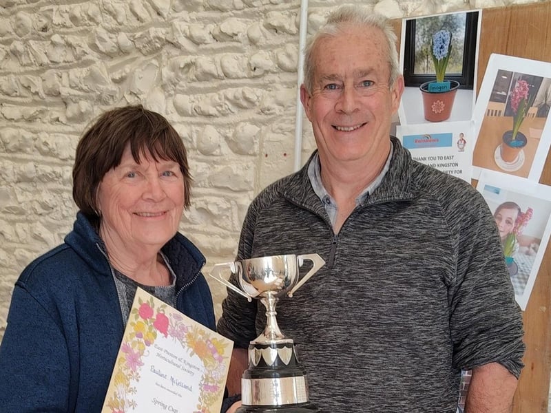 Pauline McLelland receiving the Spring Cup for best flower exhibit from Simon Smith