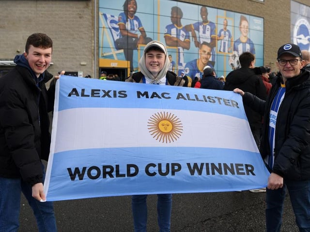 BRIGHTON, ENGLAND - JANUARY 14: Fans of Brighton & Hove Albion show their support for Alexis Mac Allister of Brighton & Hove Albion with a flag prior to the Premier League match between Brighton & Hove Albion and Liverpool FC at American Express Community Stadium on January 14, 2023 in Brighton, England. (Photo by Mike Hewitt/Getty Images)