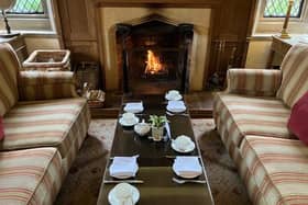 The table is set for afternoon tea in front of a roaring log fire at Amberley Castle.