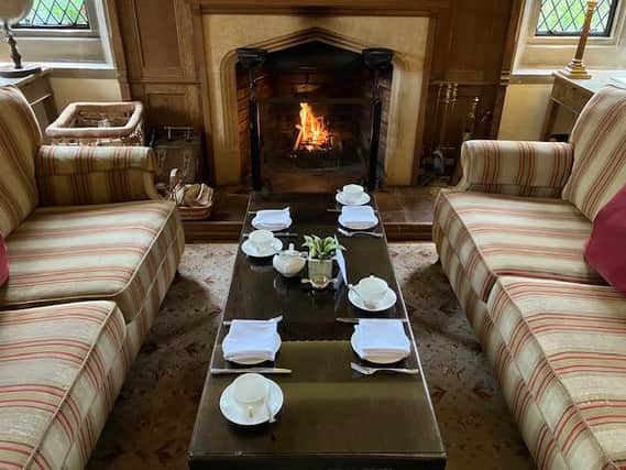 The table is set for afternoon tea in front of a roaring log fire at Amberley Castle.