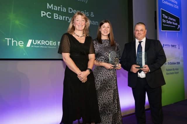 Maria Dennis being presented with the award