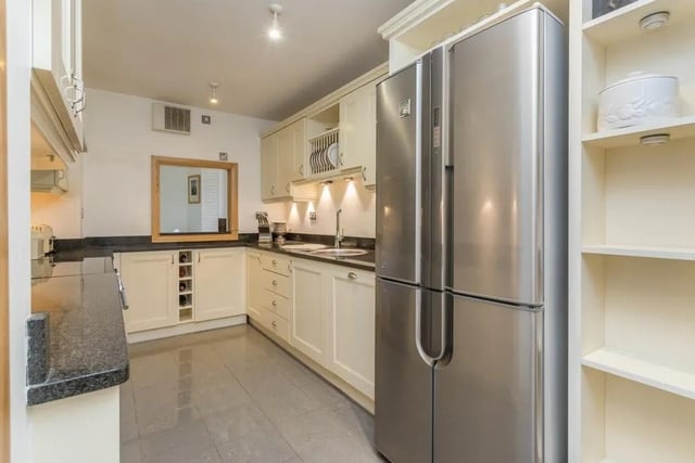 The kitchen is well fitted with Shaker style wall and base units, as well as granite worktops