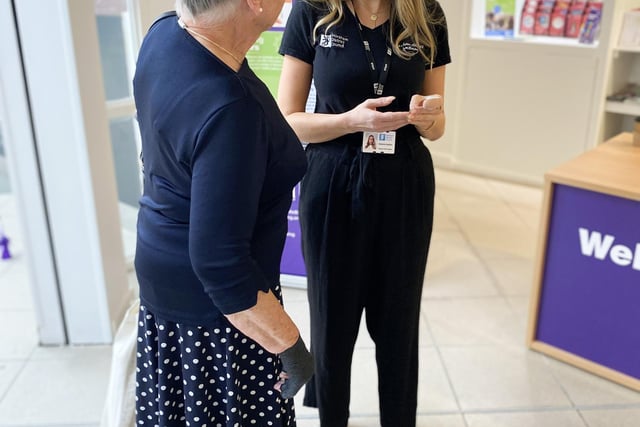 A wellbeing hub advisor speaks to a visitor  (Credit: HDC)