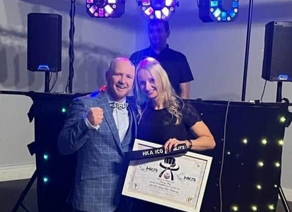 Jenny Fry receiving her 2nd Dan Black Belt and certificate
