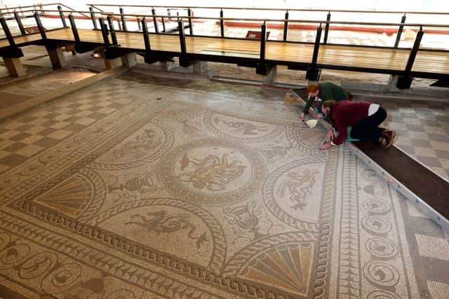The Cupid on a Dolphin mosaic, paid in the 2nd Century, is being cleaned ahead of Fishbourne Roman Palace reopening to visitors on February 11
