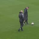 Referee Ross Joyce inspects the pitch at the Broadfield Stadium