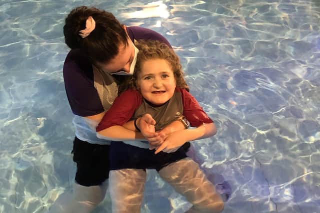 Chailey Heritage Foundation said 10-year-old Fia Kent is challenging herself to stretch out her arms and push down the heads of her supporters in the hydrotherapy pool seven times
