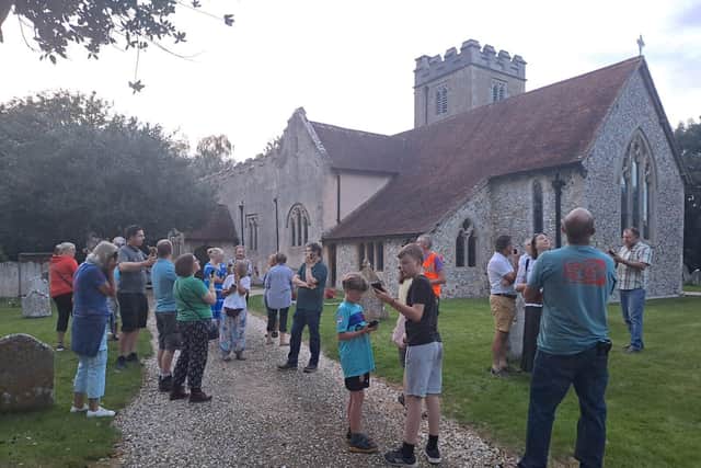 Participants using the detectors in Aldingbourne churchyard at the start of the Thursday walk