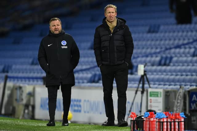 Brighton manager Graham Potter and assistant coach Billy Reid look on during the Premier League match between Brighton & Hove Albion and Aston Villa at American Express Community Stadium on February 13, 2021.