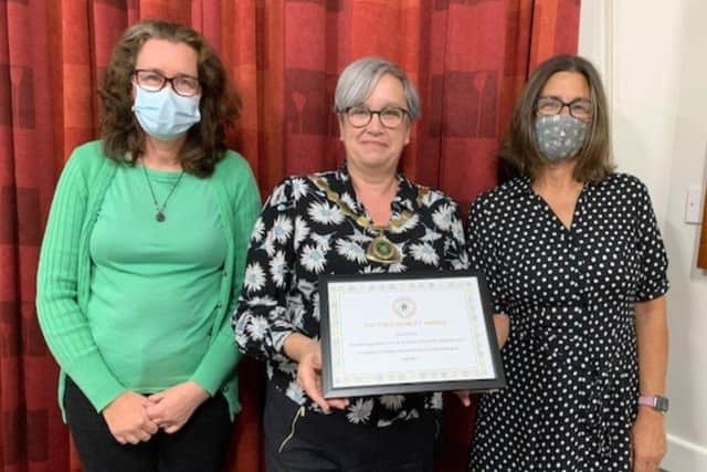 Previous winners: Angmering Parish Council chair Nikki Hamilton-Street, centre, presents the Fred Rowley Community Award to Angmering Medical Centre staff and vaccination centre volunteers in September 2021