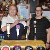 Traffers Bar in Bexhill wins CAMRA's LocAle Pub of the Year 2022 South East Sussex. Ian and Jo Ayers pictured holding the award.
