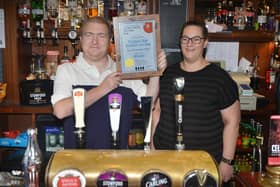 Traffers Bar in Bexhill wins CAMRA's LocAle Pub of the Year 2022 South East Sussex. Ian and Jo Ayers pictured holding the award.