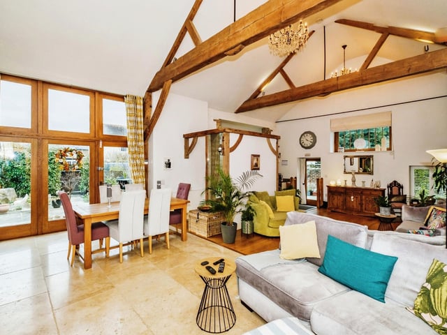 The home has an open-plan, split-level sitting/dining room and kitchen