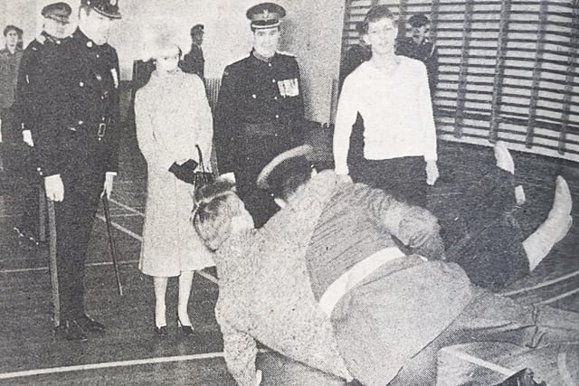 The Queen watches a mock arrest at the barracks.