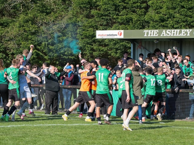 Burgess Hill Town players, fans and staff celebrate surviving in the Isthmian south east division at the end of their 0-0 draw with Beckenham