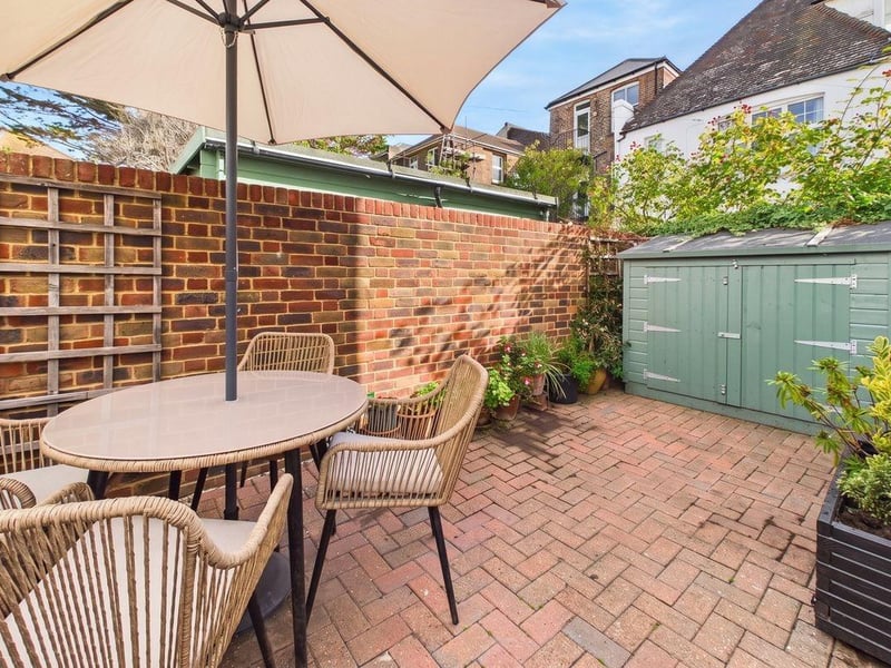 The garden has ample room for a large outdoor dining table, an array of planted pots and even a shed