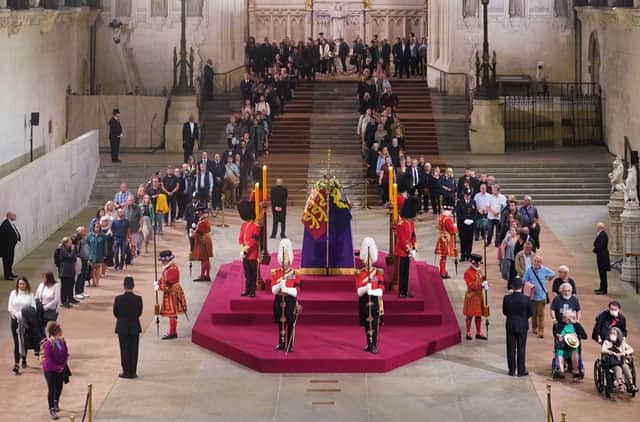 The first members of the public pay their respects as the vigil begins around the coffin of Queen Elizabeth II as it Lies in State inside Westminster Hall. (Photo by Yui Mok - WPA Pool/Getty Images)