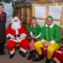 •	Linden Homes’ sales advisor Debbie Jacobs with Santa, an Elf and Buddy the Elf 