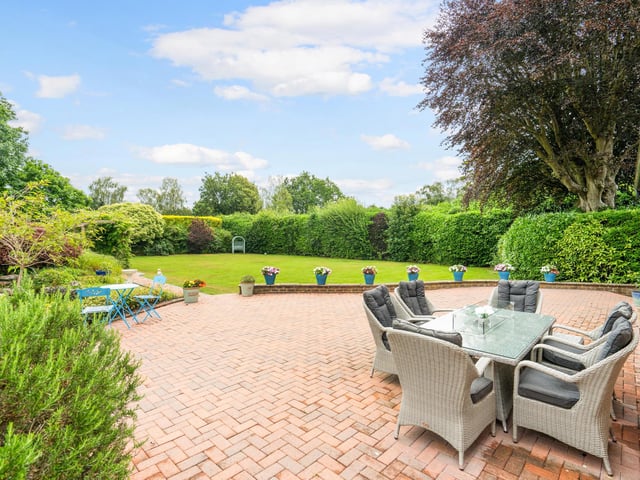 There is a large paved terrace at the back of the house