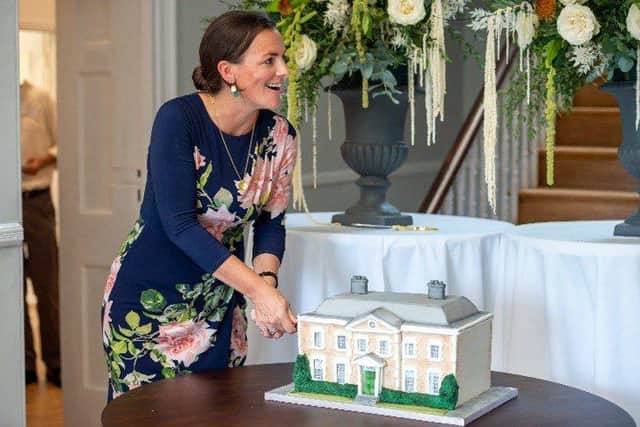 Tess St Clair-Ford, Founding Principal of OIC Brighton, cutting the cake modelled on College