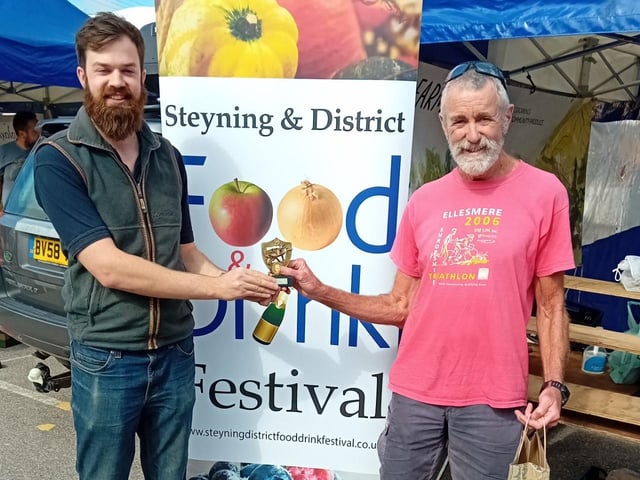 Adrian Brown accepts the Champion Allotment Trophy on behalf of his wife Alison