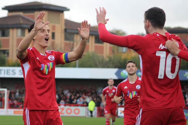 Tom Nichols and Ashley Nadesan celebrate a goal against Mansfield