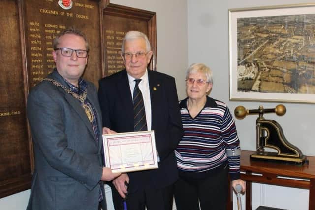 Jack Bennett, with his wife Jenny, receives a certificate of appreciation from Burgess Hill town mayor Peter Chapman.