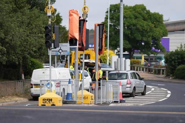 Temporary traffic signals remain in place outside the Lyons Farm retail park in Worthing. Photo: Eddie Mitchell