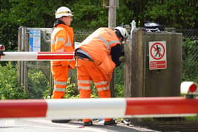 Staff at the level crossing in Adversane Lane, Billingshurst, working to repair the damaged line.